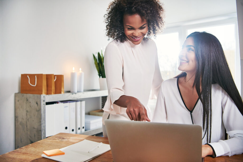 Two contemporary designers working together at laptop